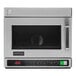 A stainless steel Amana commercial microwave with the door open.