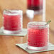 two glasses with red liquid on a table