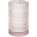 A close-up of a Fortessa pink beverage glass with a pattern of dots.