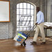 A man using a Cosco hand truck to move boxes.