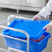 A person in white gloves holding a blue Choice lid for a meat lug.