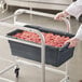 A person holding a dark gray Choice meat tote filled with ground meat.