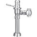 A chrome Sloan water closet flushometer with a wheel handle on a silver metal pipe.