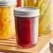 A Choice half-pint glass canning jar of jam with a silver lid.