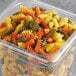 A plastic container of Barilla Tri-Color Rotini Pasta.