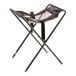 A brown assembled infant seat cradle with a metal frame and fabric seat.