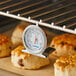 An AvaTemp oven thermometer on a rack of food.