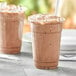 Two cups of mocha frappe made with Capora Mocha Frappe Mix on a table.