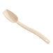 A beige plastic spoon with a handle.