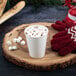 A Dart white ThermoGuard paper hot cup with hot chocolate and marshmallows on a wood table.