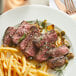 A plate with a Warrington Farm Meats coulotte steak and french fries.