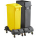 A Lavex rectangular recycle station with black and yellow lids on wheels.