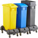 A Lavex rectangular recycle station with blue, yellow, and black lids on wheels.