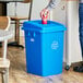 A man opening a blue Lavex recycle bin with a bottle/can lid.