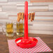A red polypropylene server with food on it and a red handle.