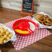 A table with a group of food in a red HS Inc. Polypropylene Chile server.