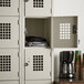 A white metal Winholt locker with perforated doors.