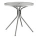 A Lancaster Table & Seating round table with a metal base.