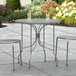 A Lancaster Table & Seating outdoor table on a patio.