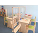 A classroom with a Whitney Brothers standing floor partition separating wooden desks and chairs.