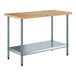 A wood top work table with a galvanized metal base and adjustable undershelf.