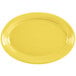 A yellow oval platter with a white background.