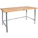 A John Boos wood top work table with stainless steel legs.