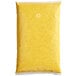 A yellow plastic bag with red speckled substance.