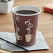 A Dart ThermoGuard paper hot cup with a coffee design on it.