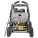 A Simpson pressure washer with a metal frame and a hose attached.