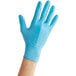 a hand wearing a blue glove