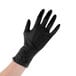 a hand wearing a black glove