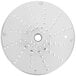 A white circular metal Robot Coupe grating/shredding disc with holes.