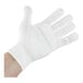 A hand wearing a white Mercer Culinary Millennia level cut-resistant glove.
