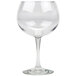 A clear Tritan plastic gin and tonic glass with a stem.