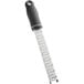 A stainless steel handheld shaver with a black handle and blade with holes.