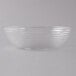 A clear Camwear round ribbed bowl on a white surface.