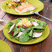 A Fiesta lemongrass luncheon plate with salad on a table.