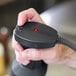 A hand holding a black and red Sammic XM-21 immersion blender.