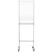 A white MasterVision standing desk with wheels.