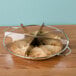 A stainless steel pie cutter with 8 blades in a metal pie.