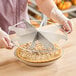 A person using a Choice stainless steel pie cutter to cut a pie.