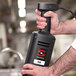 A person using a Sammic heavy-duty immersion blender with a whisk attachment.