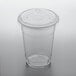 A clear Choice PET plastic cup with a flat lid on a table.