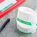 A roll of Noble Products Universal Day of the Week labels next to a pen.