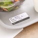 A plate of salad with a Noble Products hospital label on it on a hospital tray.