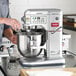 A man using an Estella EMIX8 commercial mixer to mix flour and liquid.