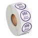 A roll of white paper with purple labels.