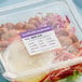 A plastic container of salad with a Noble Products allergen label on it.