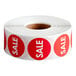 A roll of red Point Plus sale labels with white text.